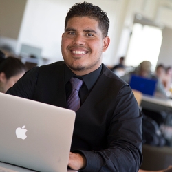 Man dressed in a suite using a laptop computer